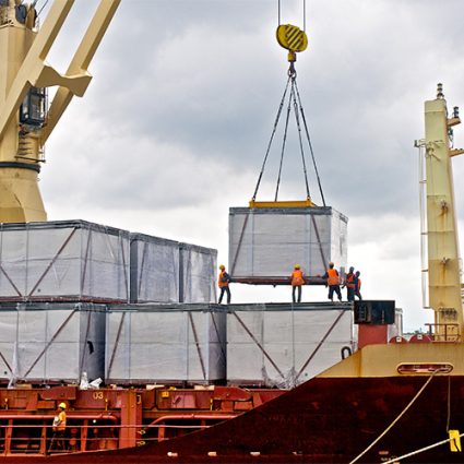 Loading cargo into the ship in port shipyard