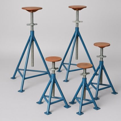 Five blue metal adjustable stools with wooden tops