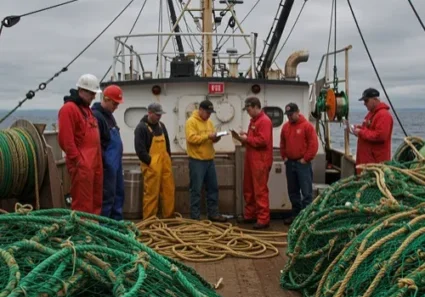 Fishermen meeting on trawler with nets