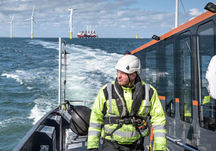 Crew member on deck of boat on offshore wind farm