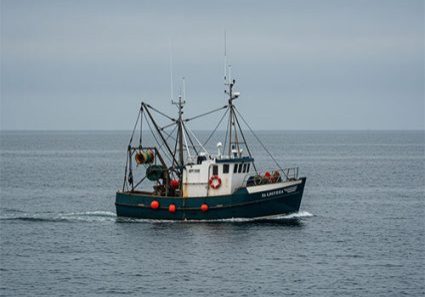 Fishing trawler boat sailing in calm open sea